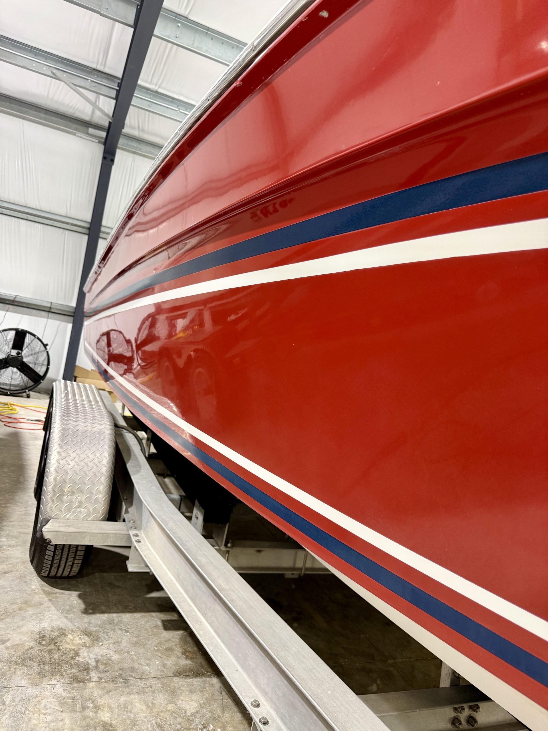 Gloss restored red boat finish